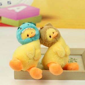 Detail of plush yellow duck pendants wearing blue dinosaur and brown bear hoods
