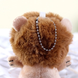 Macro detail of plush lion keychain showing brown fluffy mane and silver bead chain