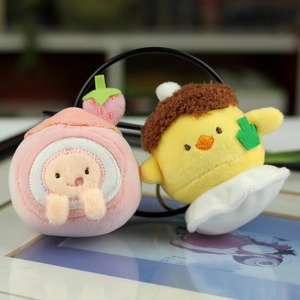 Close-up of plush strawberry cake and chick pendants with soft texture and metal rings