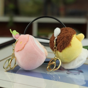 Detail of plush strawberry and pudding charms with gold metal lobster clasps and keychains