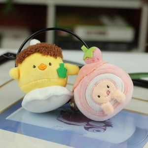 Detail of plush strawberry cake and chicken charms with soft texture and embroidery