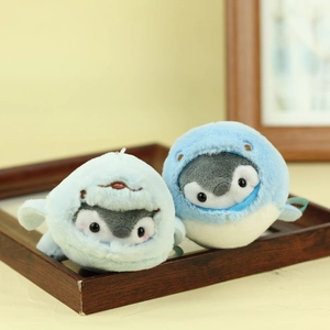 Close-up of cute penguin plush keychains in shark hoodies with detailed embroidery