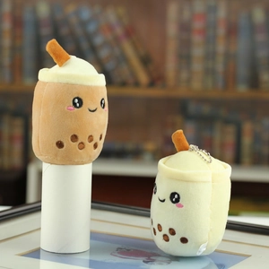 Detail of plush milk tea cup keychains in brown and white with cute facial embroidery
