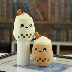 Close-up of beige and brown plush bubble tea keychains with cute cartoon facial embroidery