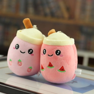 Close-up of strawberry and watermelon plush milk tea cup keychains with metal chains