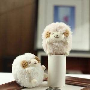 Detailed close-up of pink and white plush sheep dolls with soft lamb wool texture and horns