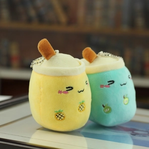 Close-up of cute plush milk tea cup keychains with fruit embroidery and metal chains