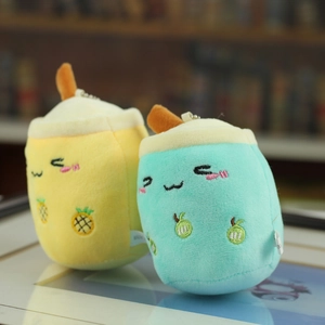 Close-up of plush milk tea keychains with pineapple and lime embroidery details