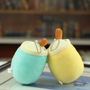 Detail of plush milk tea cup keychains in blue and yellow with metal bead chains and CE label