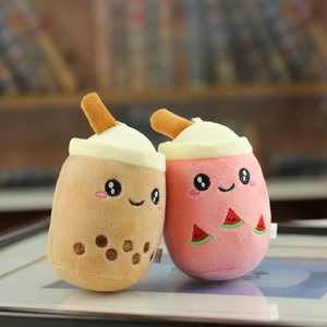 Macro detail of plush milk tea keychains with cute embroidery and soft 3D straw accents