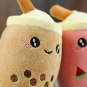Close-up of plush milk tea keychains with embroidered cute expressions and straws