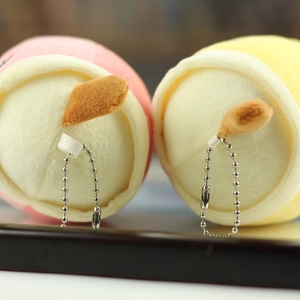 Detail of pink and yellow plush bubble tea keychains with silver bead chains for bags