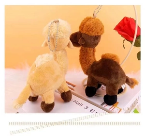 Close-up of cute camel plush keychains in beige and brown with metal chains