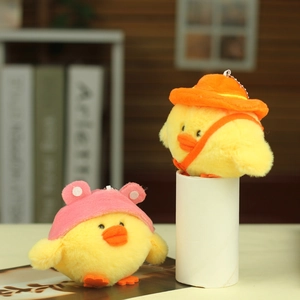 Detail of yellow plush chick charms with orange sun hat and pink animal cap options
