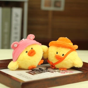 Close-up of cute plush yellow chicken charms with stylish hats and soft texture