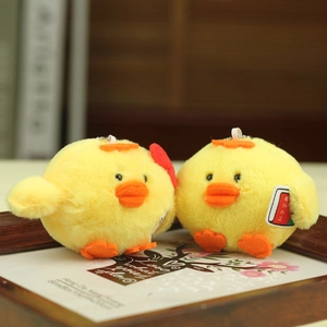 Detail of plush yellow chick charms with graduation theme and soft faux fur texture