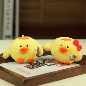 Cute yellow plush chick keychains with red bow and drink print in a wooden frame