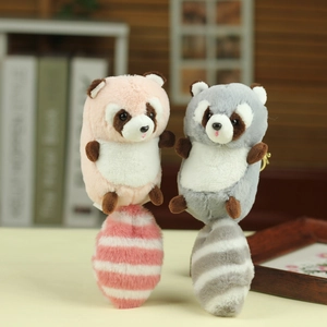 Cute plush raccoon keychains in grey and pink with fluffy tails and metal hooks