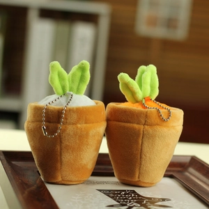 Cute plush carrot bunny pendants with green leaves and silver chains on wooden tray
