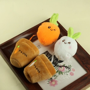 Close-up of cute plush radish rabbit dolls in small brown embroidered flower pots