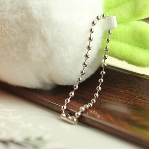 Close-up of the plush rabbit keychain with a silver metal bead chain and soft texture