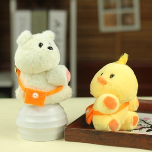 Cute plush bear and duck keychain charms with pearl straps on a white pedestal display