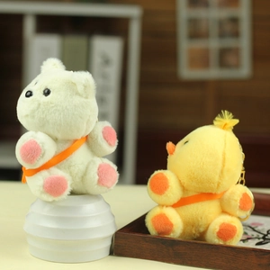 Detail view of plush bear and duck pendants with orange straps and gold keychains