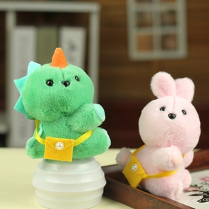Close-up of cute plush dinosaur and bunny keychains with small yellow shoulder bags
