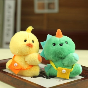 Detail of plush chick and dinosaur keychains with cute pearl mini crossbody bags