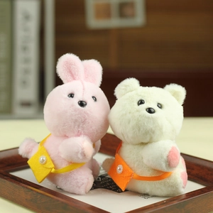 Detail of plush bunny and bear keychains with colorful felt crossbody bags and pearl beads
