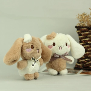 Detailed view of two plush Cinnamoroll charms with Just for you ribbons and metal rings