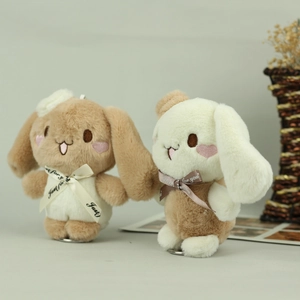 Detailed macro view of soft plush rabbit pendants with heart blush and ribbon bows