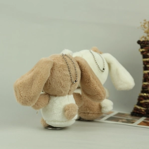 Detail view of the soft back and round tails of two plush bunny keychains in a set