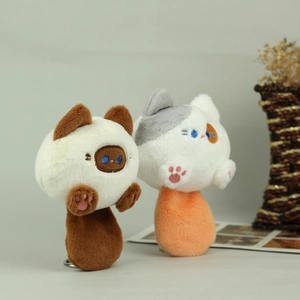 Detailed view of plush cat pendants with embroidered paws and metal keyrings
