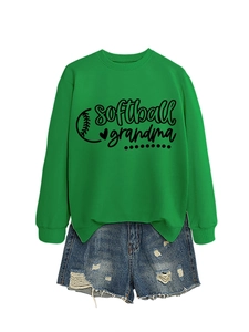 Detail view of softball grandma print on a green crewneck sweatshirt and denim shorts