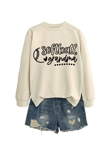 Flat lay of cream Softball Grandma sweatshirt with vintage graphic and denim shorts