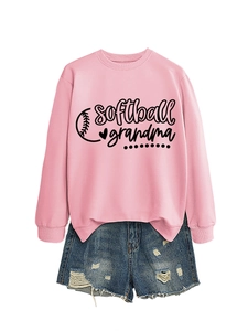 Flat lay of pink softball grandma sweatshirt paired with distressed denim shorts