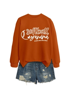 Detail of orange softball grandma sweatshirt paired with distressed denim shorts