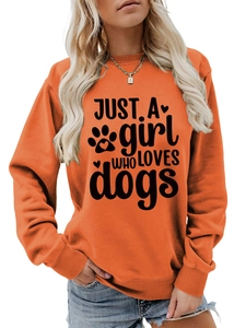 Close-up of bright orange crewneck sweatshirt featuring Just a girl who loves dogs print