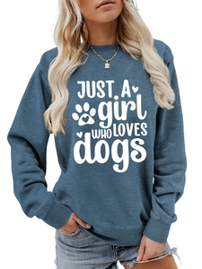 Close-up of blue crewneck sweatshirt featuring white Just a Girl Who Loves Dogs print