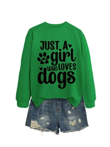 Flat lay of green sweatshirt with 'JUST A girl WHO LOVES dogs' print and denim shorts