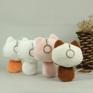 Rear view of four colorful plush cat keychains with silver metal rings and soft fur
