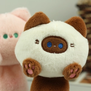 Macro view of plush cat pendant showing fine embroidery and soft faux fur texture