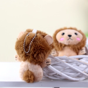 Detail of cute plush lion keychain with bead chain and soft faux fur texture in a basket
