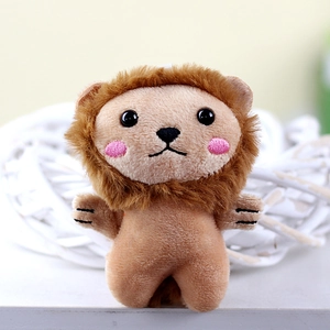 Close-up of cute plush lion keychain with pink blush embroidery and soft fur textures