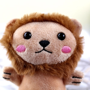 Close-up of the plush lion keychain showing detailed facial embroidery and soft mane texture