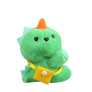 Cute green plush dinosaur toy with yellow crossbody bag and small white pearl detail