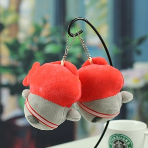 Close-up of two red and grey penguin plush pendants with silver bead chains on a black rack