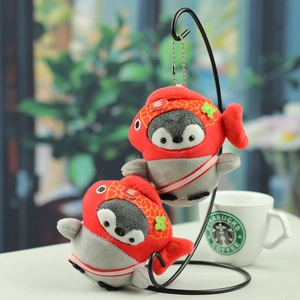 Close-up of cute plush penguin pendants with red koi fish hat and silver ball chain