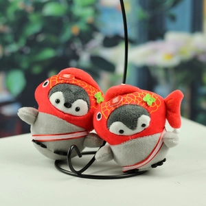 Detail of two plush penguin keychains with red koi fish hoods on a black wire stand